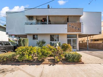 Reseda multi-family for rent - A white two-story building with a balcony and a sign that reads "7502" on the front.