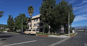 Los Angeles multi-family for rent - A street view with a tan van and a palm tree.