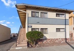 Torrance multi-family for rent - A two-story building with a staircase leading up to the front door.