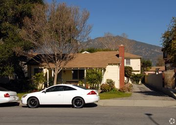 Arcadia multi-family for rent - A white car is parked in front of a house.