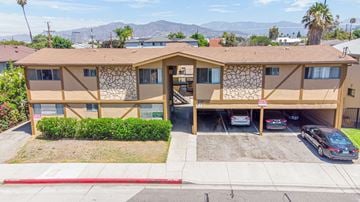Glendale multi-family for rent - A building with a brown and tan exterior and a red curb in front.