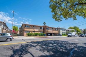 Glendale multi-family for rent - A sunny day at a street with cars and a building.