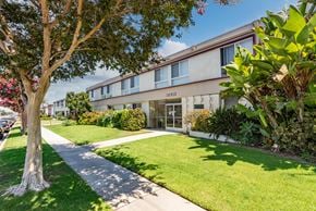 Torrance multi-family for rent - A tree stands in front of a building with the number 16910 on it.