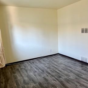 North Hollywood apartment for rent - A room with a wooden floor and white walls.