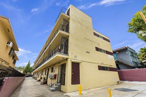 Los Angeles multi-family for rent - A yellow building with the number 2401 on it.
