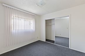 Los Angeles multi-family for rent - A room with a sliding door and a window with blinds.