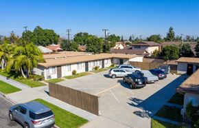 Norwalk multi-family for rent - A row of houses with cars parked in front.