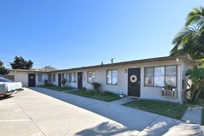 Norwalk multi-family for rent - A row of houses with a clear blue sky above.