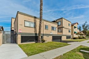 Lawndale multi-family for rent - A modern building with a palm tree in front.