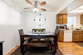 Lawndale multi-family for rent - A dining room with a table set for two and a clock on the wall.