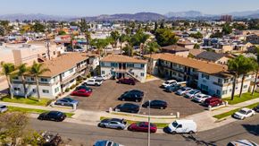 Los Angeles multi-family for rent - A parking lot with several cars and a building in the background.