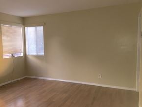 Los Angeles apartment for rent - A room with wooden floors and a window with blinds.
