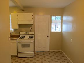 Los Angeles apartment for rent - A kitchen with a white stove and a white door.