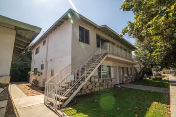 La Puente multi-family for rent - A house with a white exterior and a stone staircase leading to the front door.
