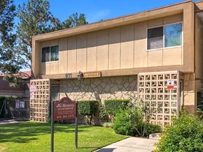 Monrovia multi-family for rent - The image shows a building with a sign that reads "JG Monterey Apartments" and a phone number.