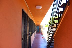 Huntington Park multi-family for rent - A long hallway with a staircase on the right.