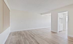 Los Angeles multi-family for rent - A room with wooden flooring and white walls.