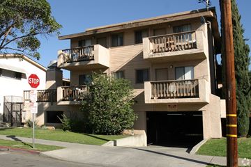 Long Beach multi-family for rent - A building with a stop sign in front of it.