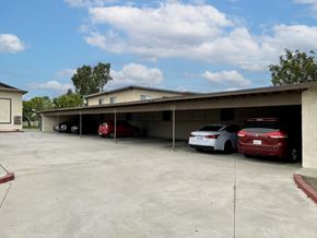 Fontana multi-family for rent - A parking garage with a few cars parked in it.