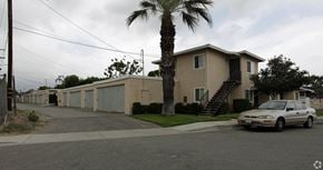 Upland multi-family for rent - A white car is parked in front of a house.