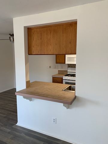 Harbor City multi-family for rent - A kitchen with a wooden cabinet and countertop.