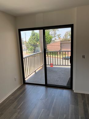 Harbor City multi-family for rent - A balcony with a view of a street and houses.