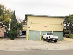 Lynwood multi-family for rent - A white pickup truck is parked in front of a yellow garage.