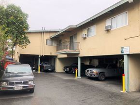 Lynwood multi-family for rent - A parking garage with a few cars parked in it.