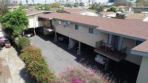 Lynwood multi-family for rent - A car is parked in the driveway of a house.