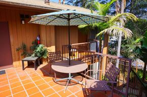 Toluca Lake multi-family for rent - A patio with a table and chairs under an umbrella.