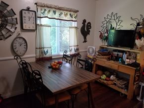 Northridge multi-family for rent - A wooden dining table with chairs and a bowl of fruit on it.