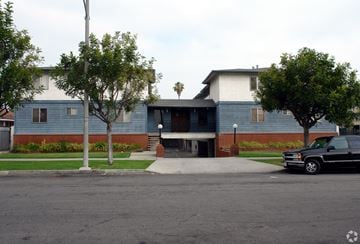 Inglewood multi-family for rent - A black truck is parked on the street in front of a blue building.