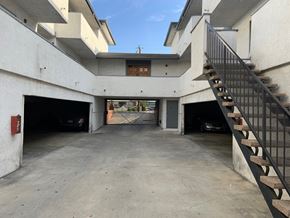 Inglewood multi-family for rent - A parking garage with a staircase on the right side.