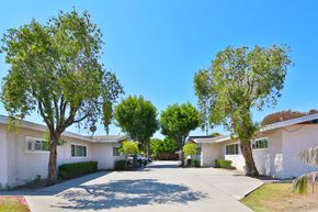 Downey multi-family for rent - A row of houses with trees in front of them.
