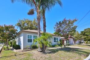 Downey multi-family for rent - A house with a palm tree in front of it.