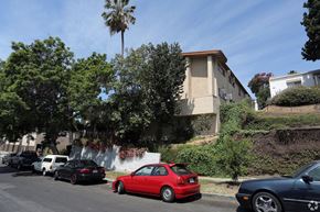 Los Angeles multi-family for rent - A red car is parked on the side of the road.