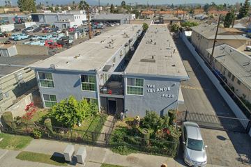 El Monte multi-family for rent - A parking lot with a white van parked in front of a building with a sign that says "The Island".