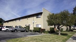 Ontario multi-family for rent - A building with a parking lot in front of it.