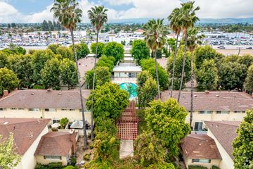 Claremont multi-family for rent - A view of a courtyard surrounded by houses and trees.