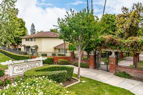 Claremont multi-family for rent - A sign that says Vista Valley Townhouses in front of a house.