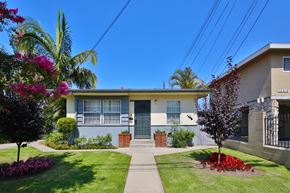 Downey apartment for rent - A house with a blue door and a small garden in front.