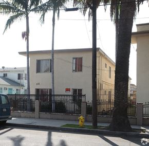 Los Angeles multi-family for rent - A house with a black fence and a yellow fire hydrant in front.