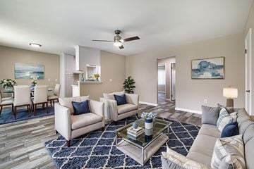 Rowland Heights multi-family for rent - A living room with a grey couch, a coffee table, and a painting on the wall.