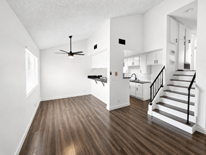 Gardena multi-family for rent - A room with a ceiling fan and wooden floors.