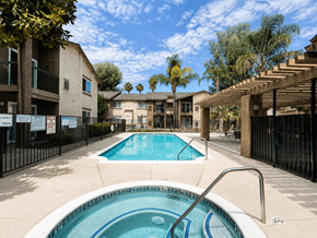 Hemet multi-family for rent - A pool in a courtyard surrounded by buildings.