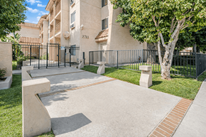 El Monte multi-family for rent - A residential building with a black gate and a tree in front.