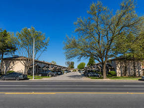 Merced multi-family for rent - A tree with green leaves stands in front of a building.