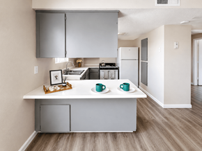Merced multi-family for rent - A kitchen with a white countertop and grey cabinets.