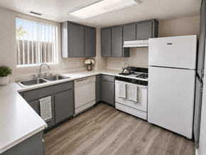 Merced multi-family for rent - A kitchen with a white refrigerator, a sink, and a stove.