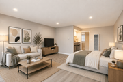 Pomona multi-family for rent - A well-lit, modern bedroom with a large bed and a cozy seating area.